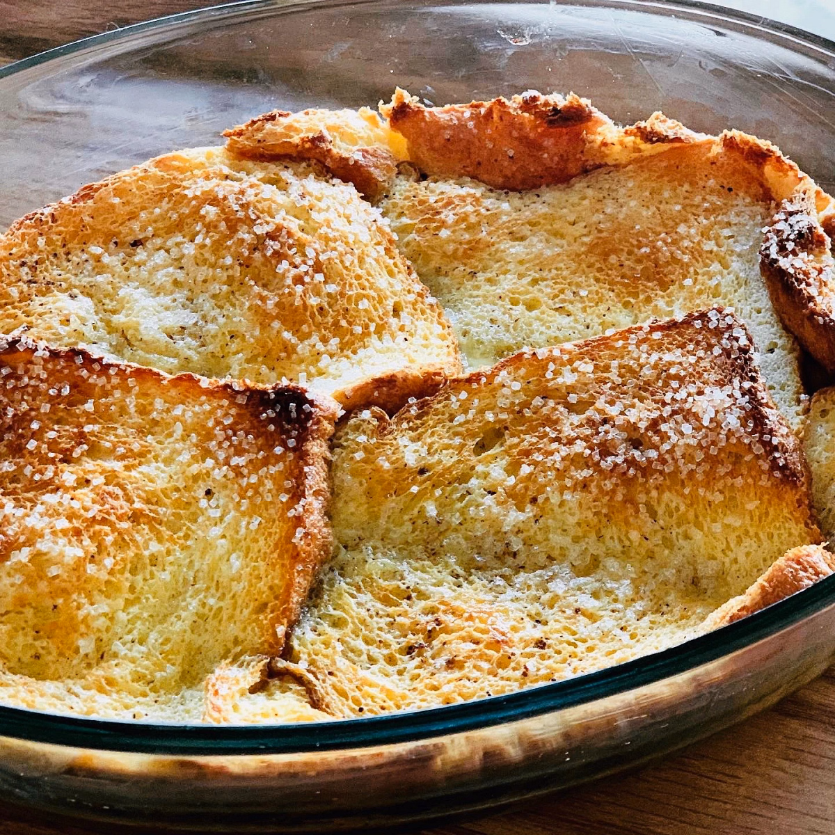 Bread pudding baked in a dish, sugar crackling on top